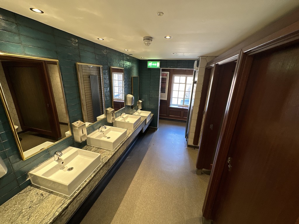 Sink area of men's toilets of Captain Ridley's Hunting Party Wetherspoon in Bletchley, Milton Keynes 