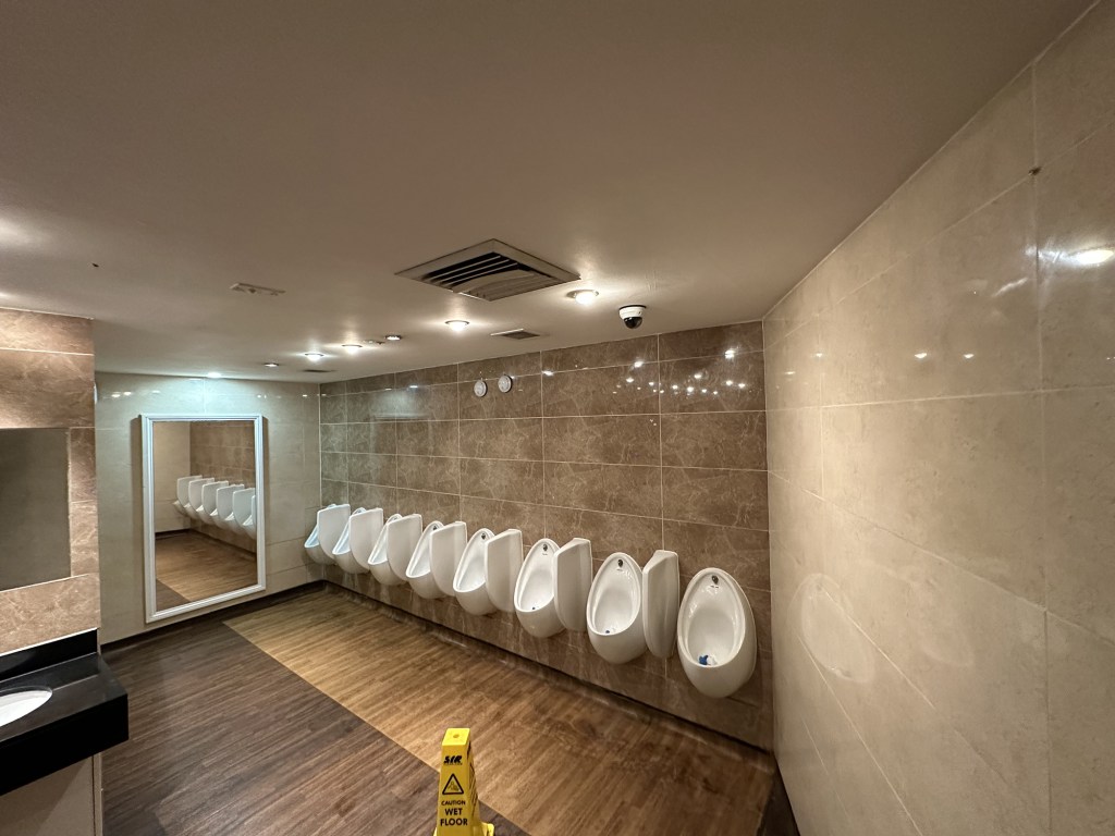 The toilets are fresh and modern, with bright lighting and marble-effect features.