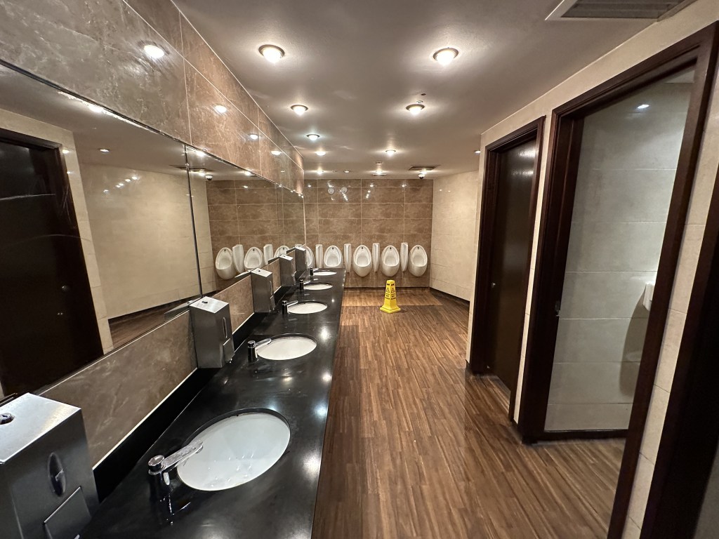 The toilets are fresh and modern, with bright lighting and marble-effect features.