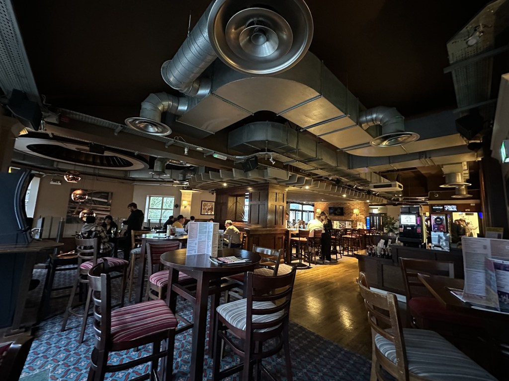 The interior has quite an industrial feel to it with exposed HVAC systems and plenty of dark wooden seating.